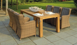 an outdoor table and grassy lawn